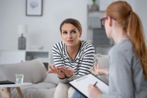 two women in office discussing bipolar disorder treatment program
