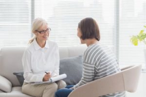 therapist explaining dialectical behavior therapy to a female client