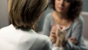 woman holding her friend's hand asking when should i seek help from a mental health professional