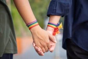 lgbtq couple holding hands and walking towards lgbtq addiction treatment session