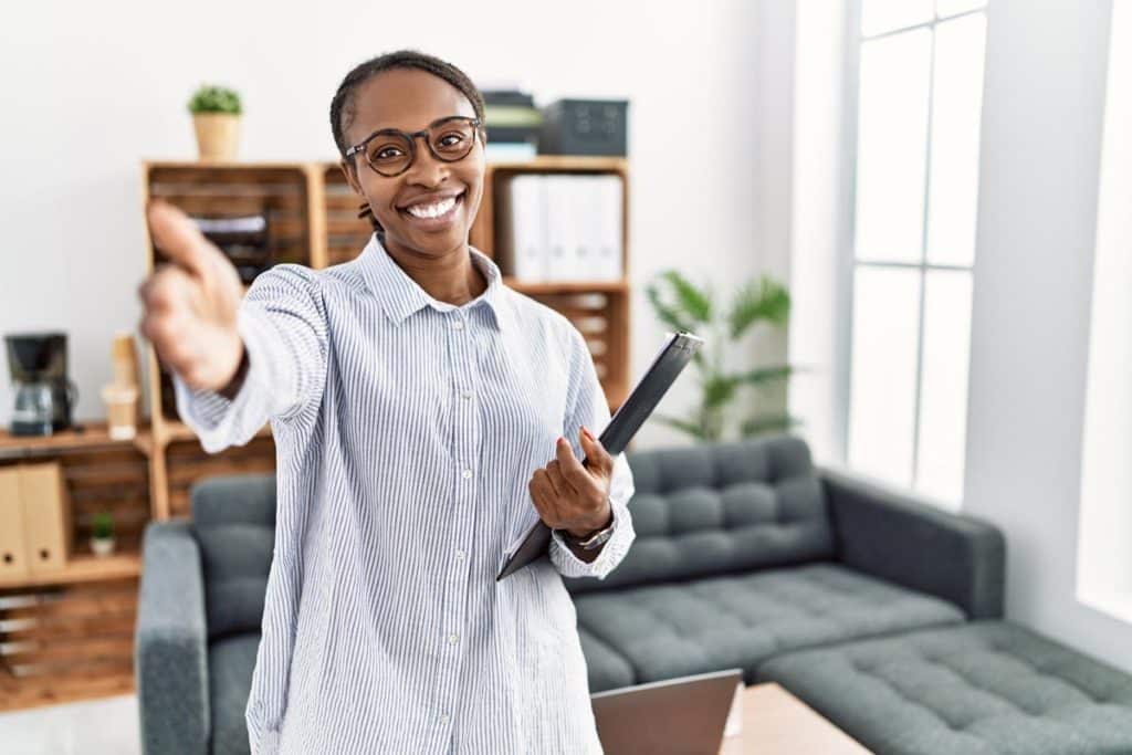 Health professional with arm out near couch, encouraging patient to discuss vivitrol treatment