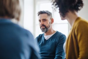 older man participating in group discussion regarding who qualifies for a vivitrol treatment program
