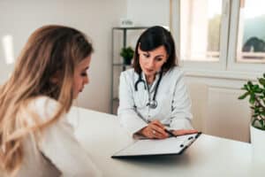 young woman talking with female behavioral health specialist asking what is the most common dual diagnosis