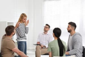 a person shares with a group in a medical detox program