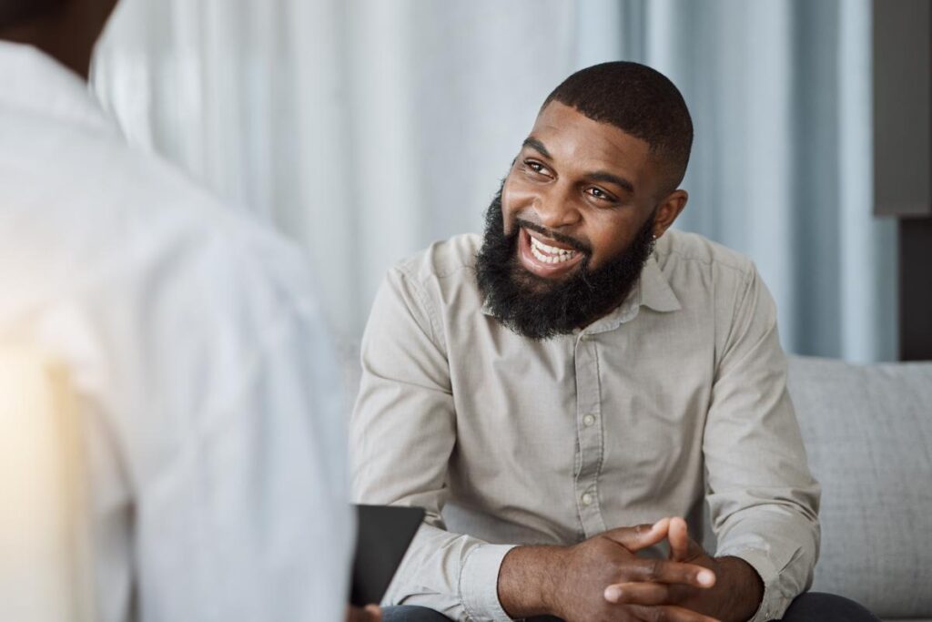 smiling young man enjoying recovery after experiencing the benefits of inpatient alcohol rehab