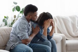 man consoling his wife asking does my loved one need opioid addiction treatment?