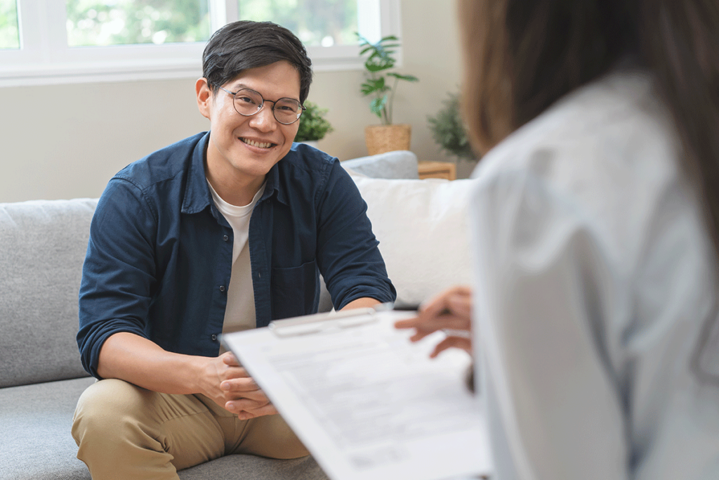 young man happily speaking with therapist about finding a medical detox center in Omaha, NE.